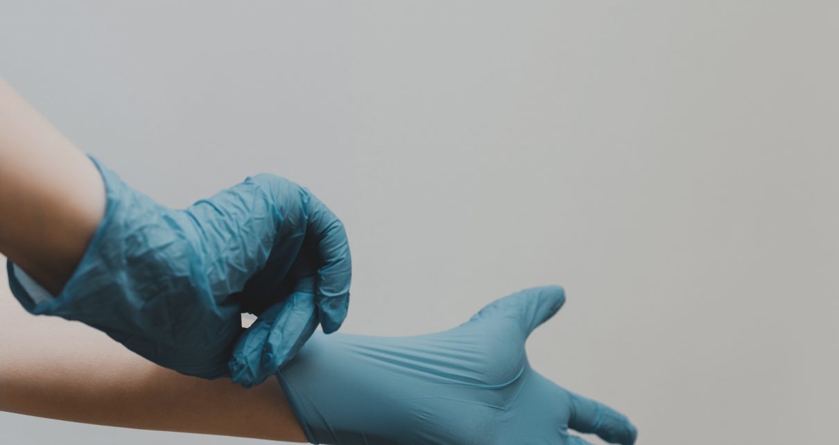person in blue gloves and blue denim jeans