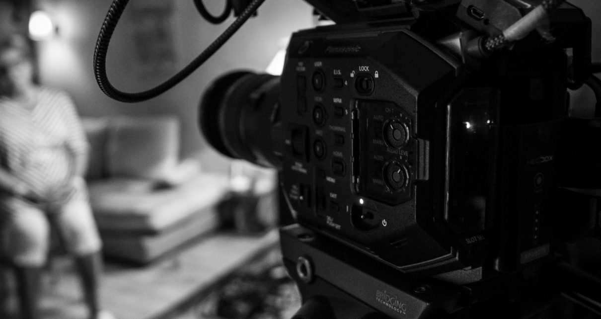 black video camera on black tripod