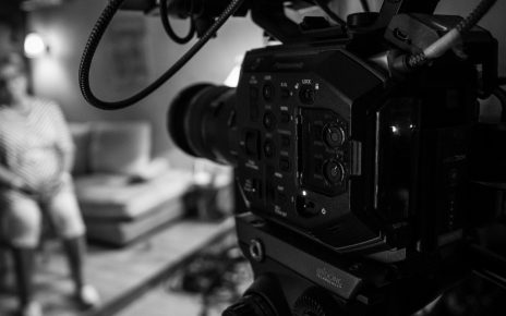 black video camera on black tripod