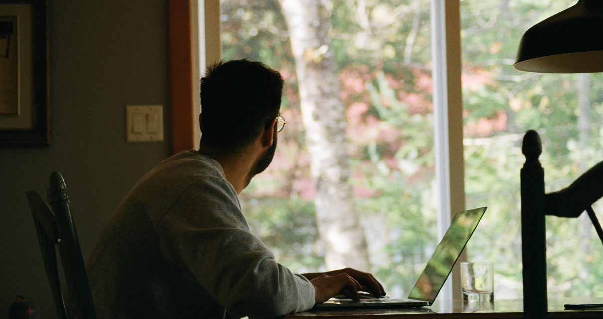 man in gray hoodie using laptop computer