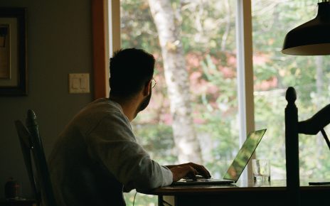 man in gray hoodie using laptop computer